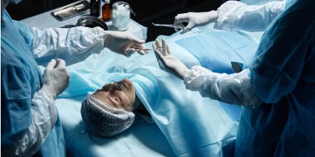 A team of urologist performing a surgery.