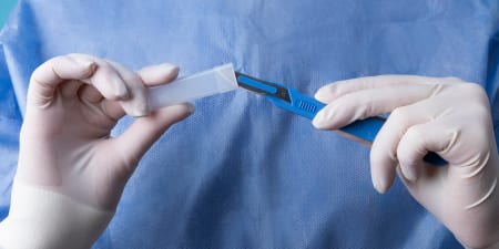 An urologist making the surgical tools ready for incisional biopsy.