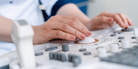 A close-up view of urologist performing an ultrasound.