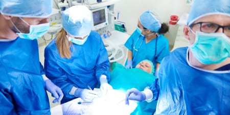 A team of urologist performing a prostate surgery.