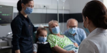 An urologist counseling a patient and her family for preventing from disease progression.