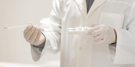 An urologist with surgical needle ready for a prostate biopsy.