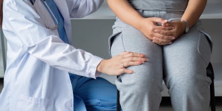 An urologist comforting a patient for urinary track infection.
