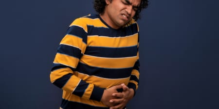 A ma suffering in pain from severe bladder damage.