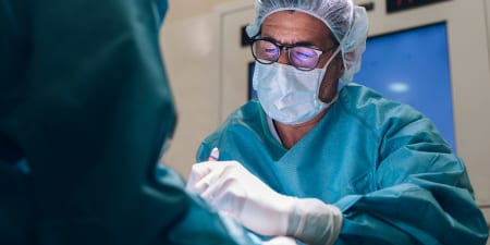 An urologist in the procedure of bladder tumor removal.