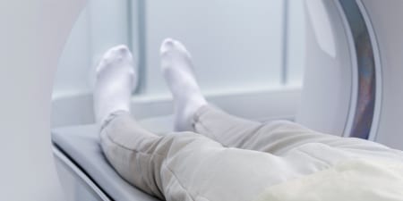 A patient undergoing a CT scan for diagnosing testicular surgery.