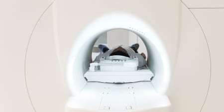 A patient undergoing a MRI scan for diagnosing testicular surgery.