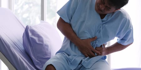 A male patient in pain illustrates trauma and severe damage resulting in removal of kidneys.