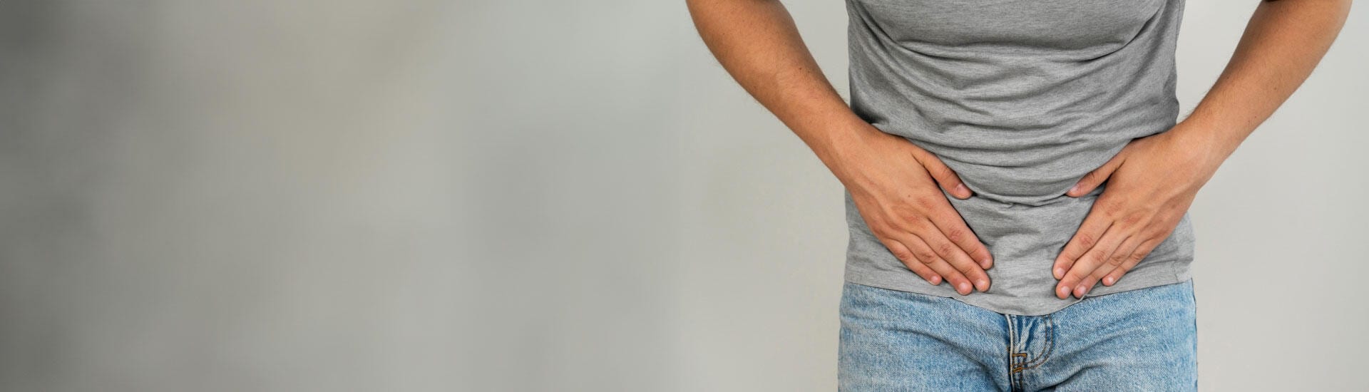 A man in pain due to urinary incontinence.