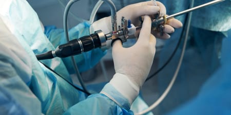 An urologist performing cystoscopy, a minimally invasive procedure.
