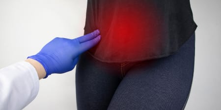 An urologist performs a physical examination on a patient.