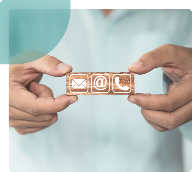 A man showing a message, @ for mail & phone icon for contacting Dr. Aarthy Urologist.