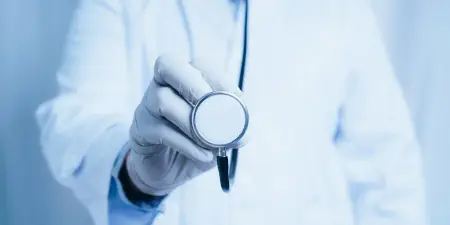 An urologist using stethoscope for physical examination.