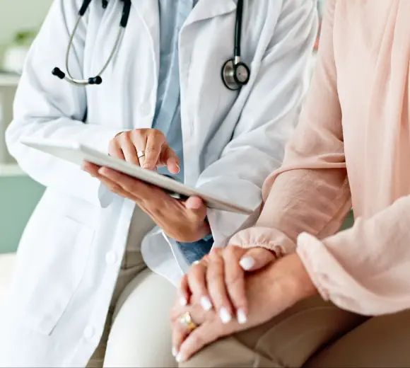An urologist discussing with a patient for personalised treatments.