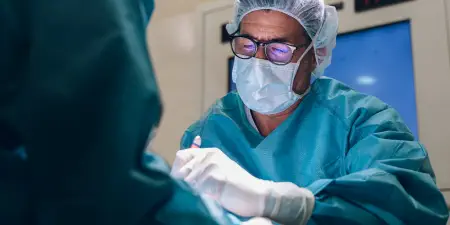 An urologist in the procedure of bladder tumor removal.