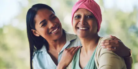 An urologist comforts a patient down with muscle-invasive bladder cancer.