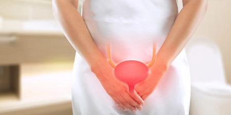 A female struggling with pain in lower abdomen due to bladder cancer.