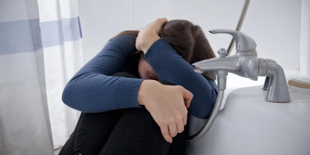 A depressed women suffering due to persistent urinary symptoms.