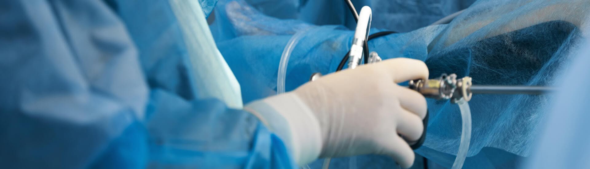 Close-up view of an urologist performing a cystoscopy surgery.